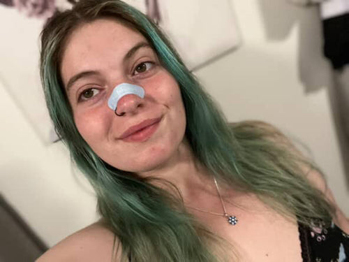 Woman Applying Nose Strip & Taking a Selfie