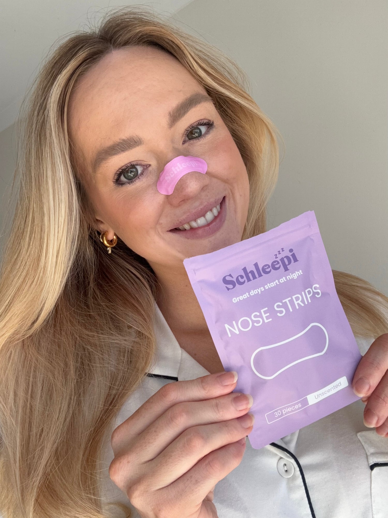 Women holding Schleepi Nasal Breathing Strip