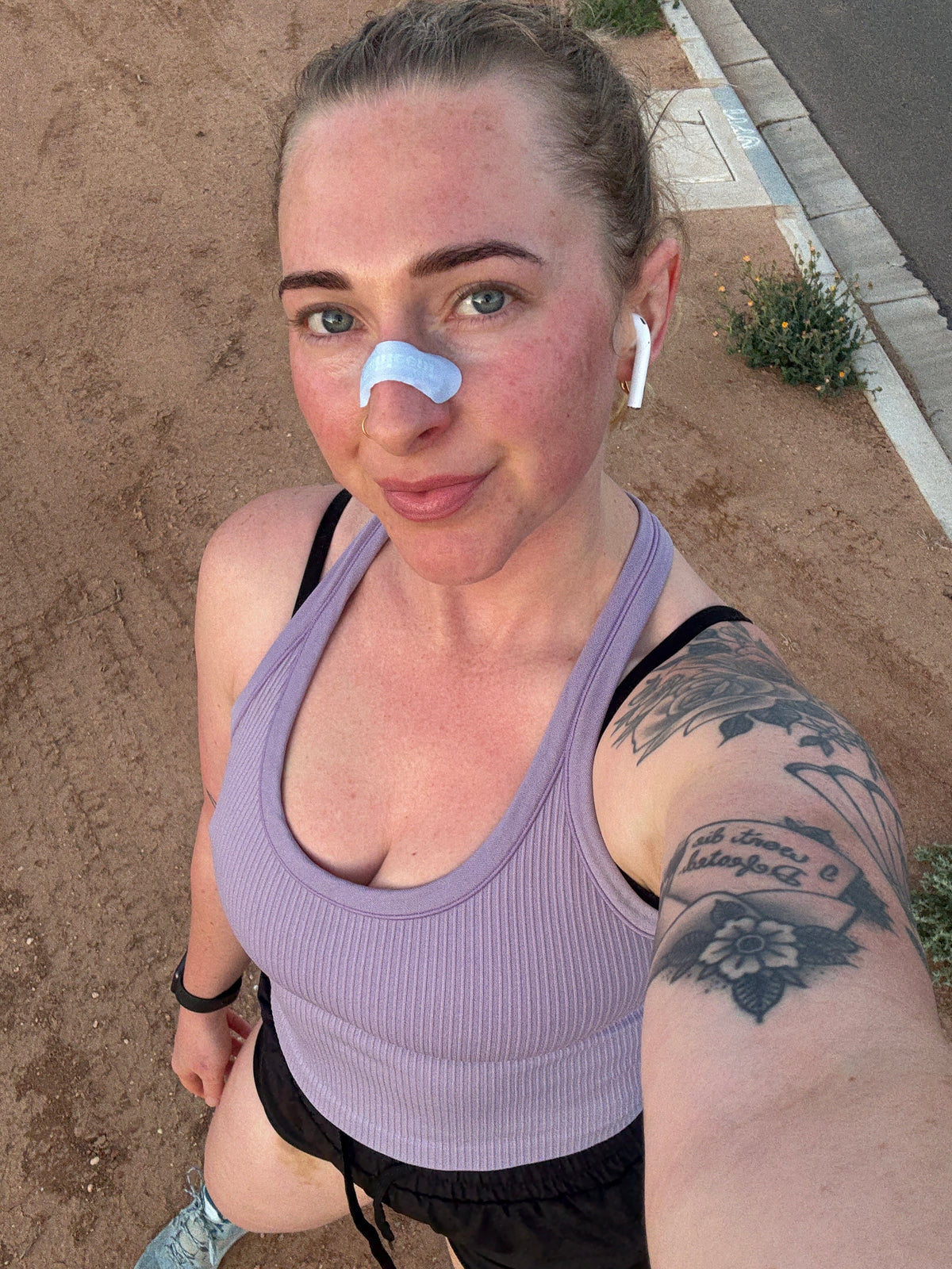 Woman Applying Nose Strip and Taking a Selfie
