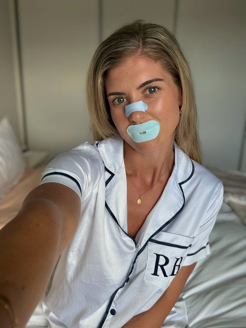 Woman wearing a skin-friendly nasal strip demonstrating a snoring solution for better sleep in Australia at home.
